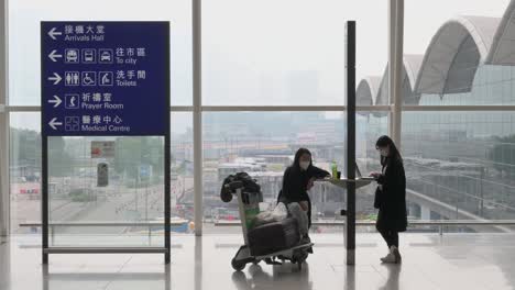 flight passengers use their electronic devices at hong kong's chek lap kok international airport