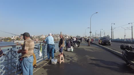 people fishing on galata bridge, istanbul