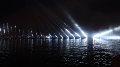 festive colorful fireworks and illumination in dark sky with beautiful reflection in water. holiday scarlet sails