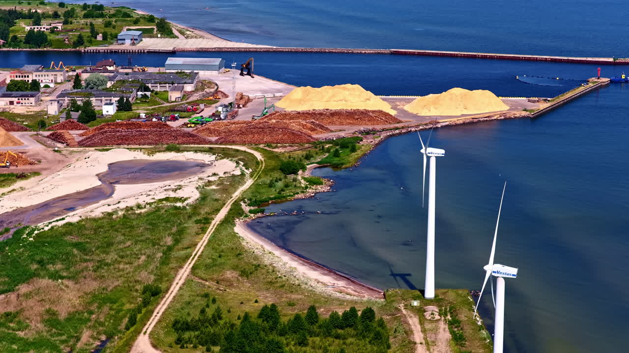 Wind turbines in an industrial mining area on the coast of Europe. Aerial