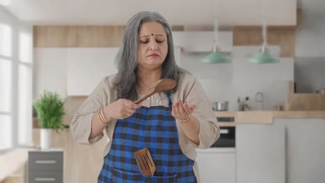 indian aged housewife cooking spicy food
