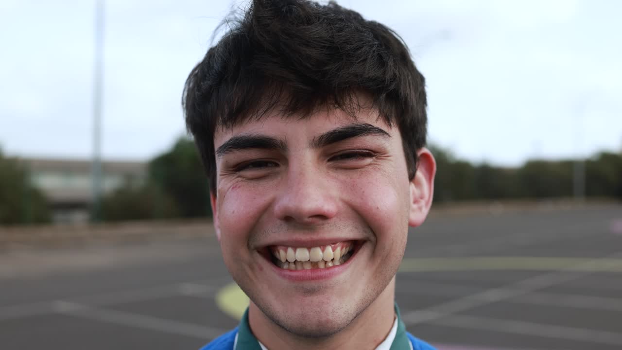 Young man smiling on camera outdoor