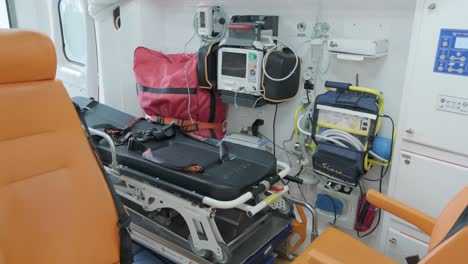 inside the ambulance, view from the sanitary compartment. different medical equipment and a stretcher.