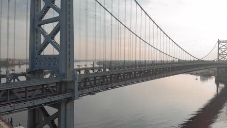 sunrise aerial drone footage of benjamin franklin bridge in philadelphia