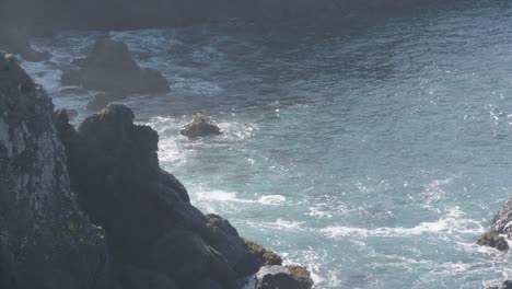 Looking-down-on-the-Pacific-Ocean-with-waves-crashing-into-the-cliffs