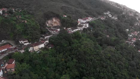 main mountain road to mining city of ouro preto in minas gerais, revealing the valley and the central square of the brazilian colonial gold capital with typical architecture on an overcast drowsy day