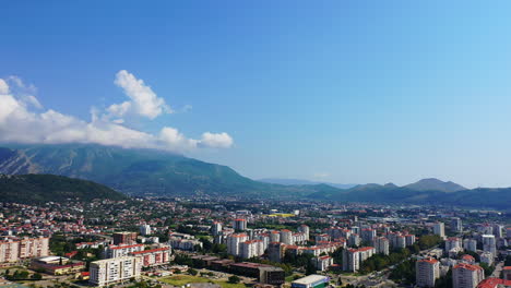 lovely view of the sunny city that scattered among the mountains and the sea. bar, montenegro from aerial perspective.
