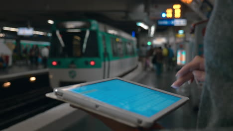 girl typing message on digital tablet in underground