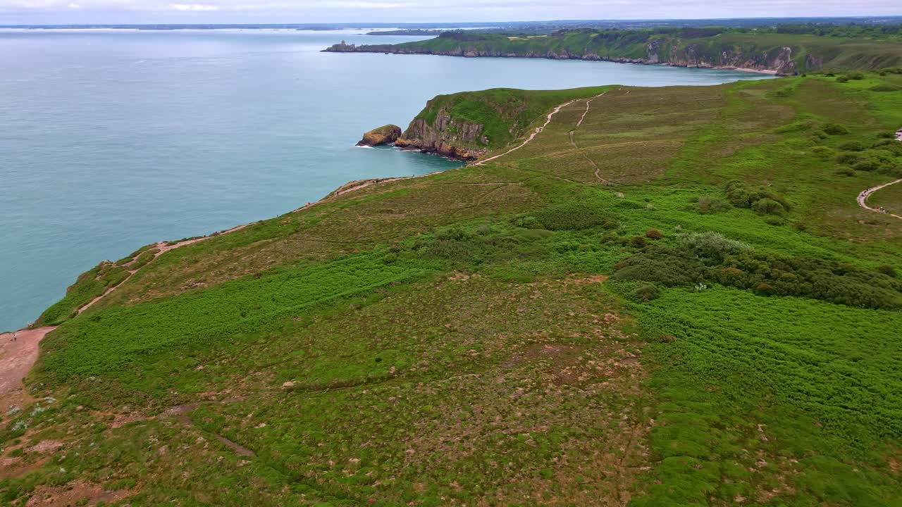 Grassy meadows extending towards the calm seaside near at Cap Fréhel peninsula, Côtes-d'Armor, Brittany, France.