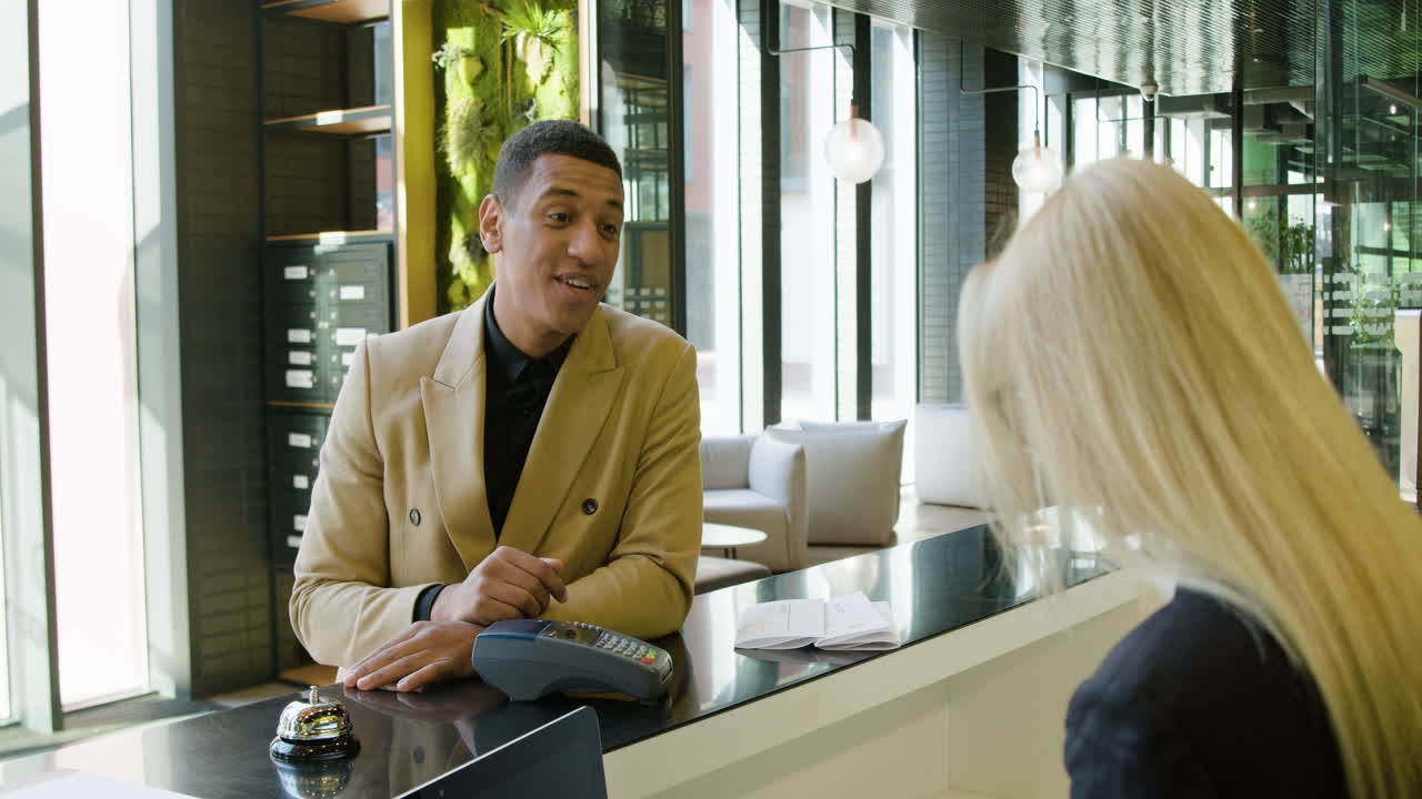 Back view of blonde receptionist taking a reservation