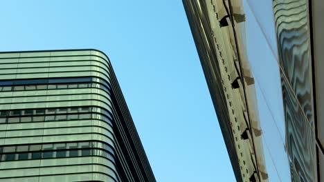 city reflections: looking up at a reflective building facade