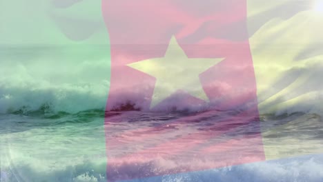Digitale-Komposition-Der-Wehenden-Kamerunischen-Flagge-Gegen-Wellen-Im-Meer