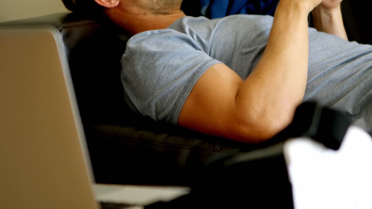 Man using mobile phone in living room 4k