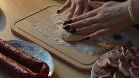rolling and kneading dough into a small pancake shape. preparing food for baking in the kitchen. traditional slavic dinner