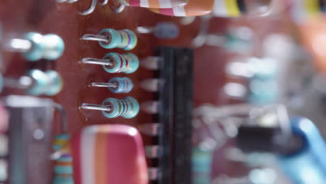 colorful electrical components arranged on circuit board, slider shot