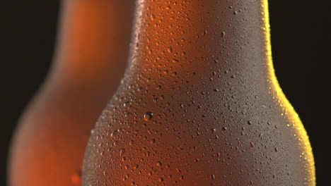 two beer bottle rotating on black background