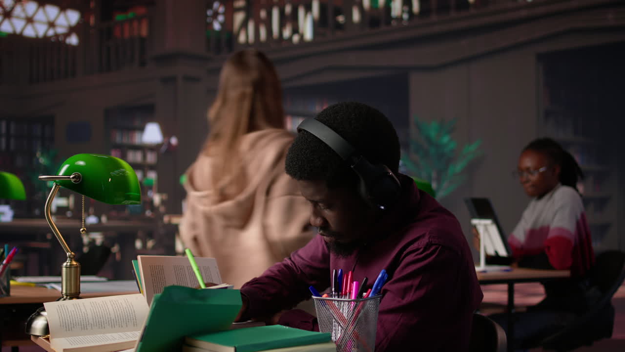 Vertical video african american guy uses ambient focus music to help with school assignment