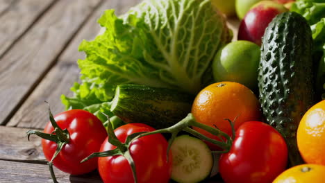 assorted fresh fruits and vegetables on a wooden table