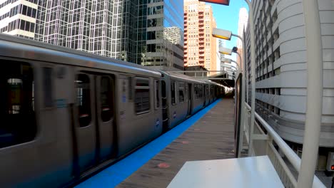 long subway train pulling into big city station