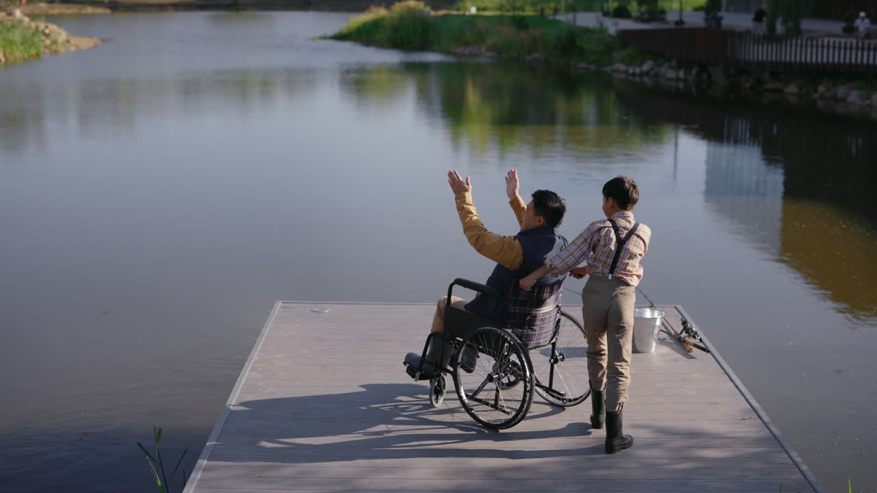 Boy and Man with Disability Enjoying Fishing by the Lake