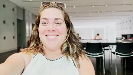 happy woman smiling while vlogging in a modern room