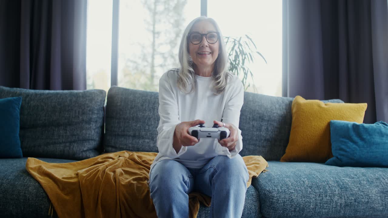 Woman playing video games on couch