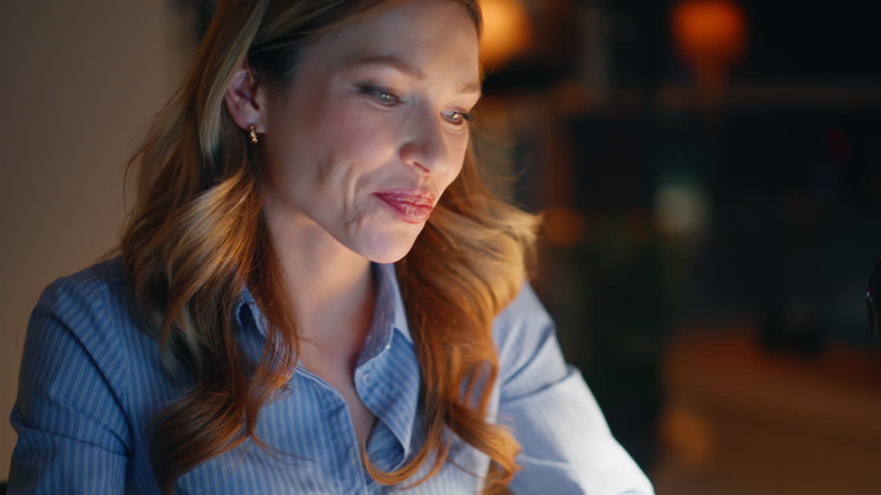 Night manager hands typing laptop writing email in dark workplace closeup