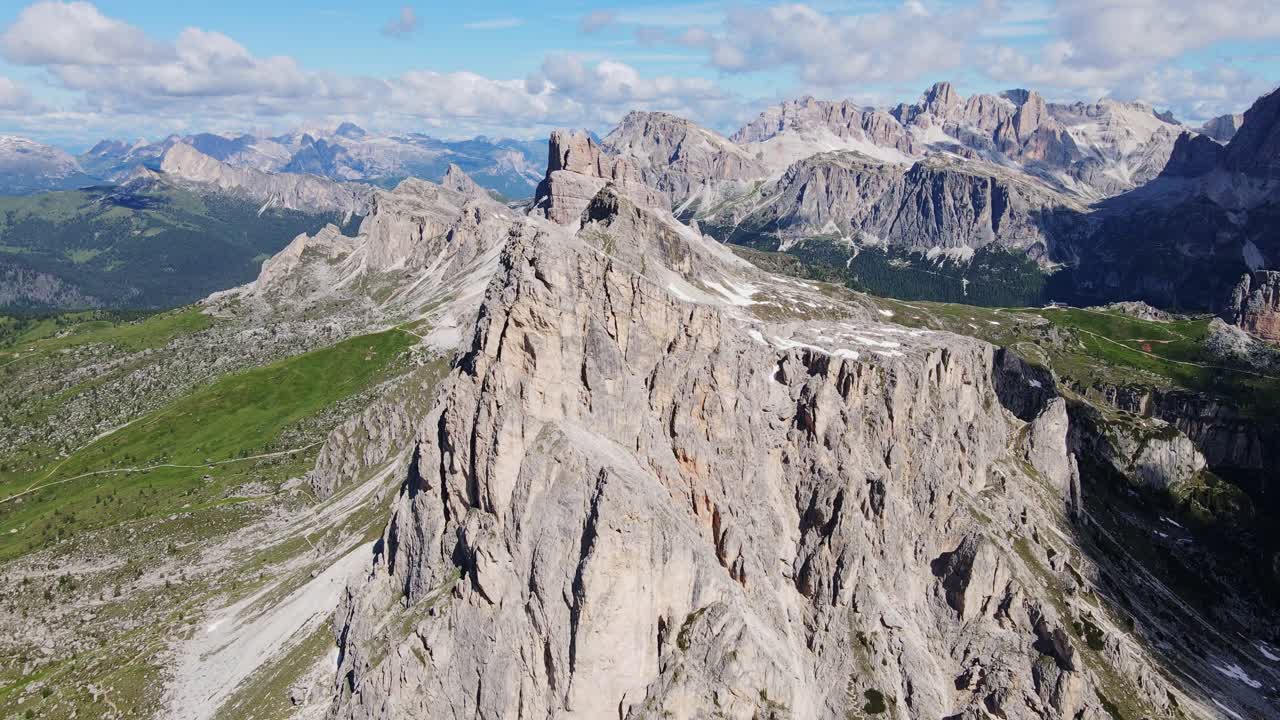 Cinematic aerial of Ra Gusela rock formation and alpine ridges in northern Italy