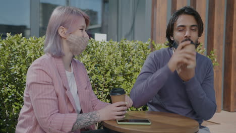 couple having coffee outdoors during pandemic