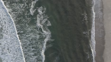 wonderful view of the ocean waves splashing to the shore - aerial shot