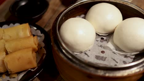 assorted dim sum dishes on a wooden table