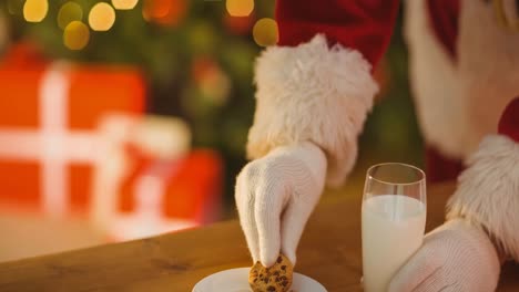 animación de la mano de santa claus tomando galletas de navidad del plato