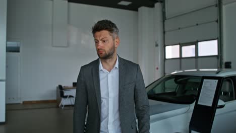 man in a car dealership