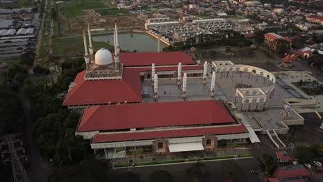 aerial view of the great mosque of central java (majt) in suset time. th sun is orange and the weather is cloudy. side view of the mosque