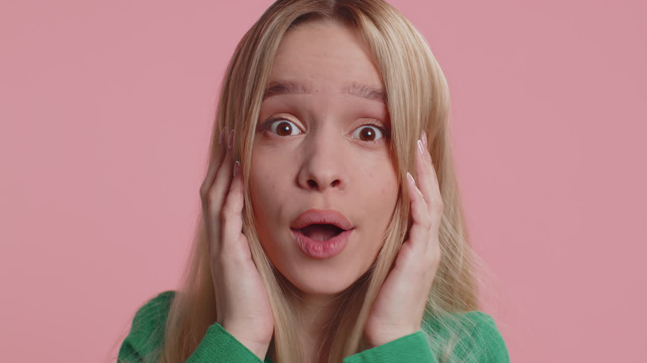 Excited amazed woman surprise looking at camera with big eyes shocked by sudden victory wow emotion