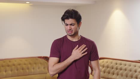 young indian man feeling discomfort in his chest