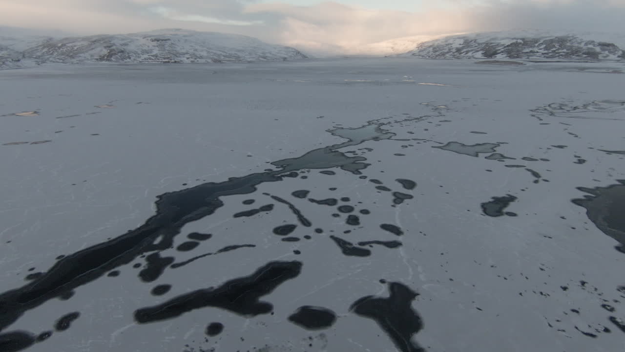 Winter scenery, frozen lake and majestic mountains, dolly forward