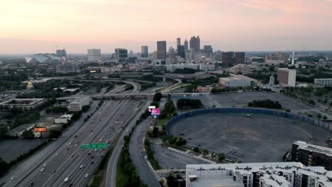 atlanta, georgia skyline at dusk with freeway traffic and drone video moving in a circle