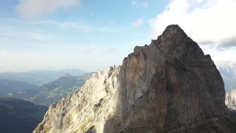 slow drone shot going sideways to the left, revealing the sharp and steep mountain ridge of dossengrat in switzerland