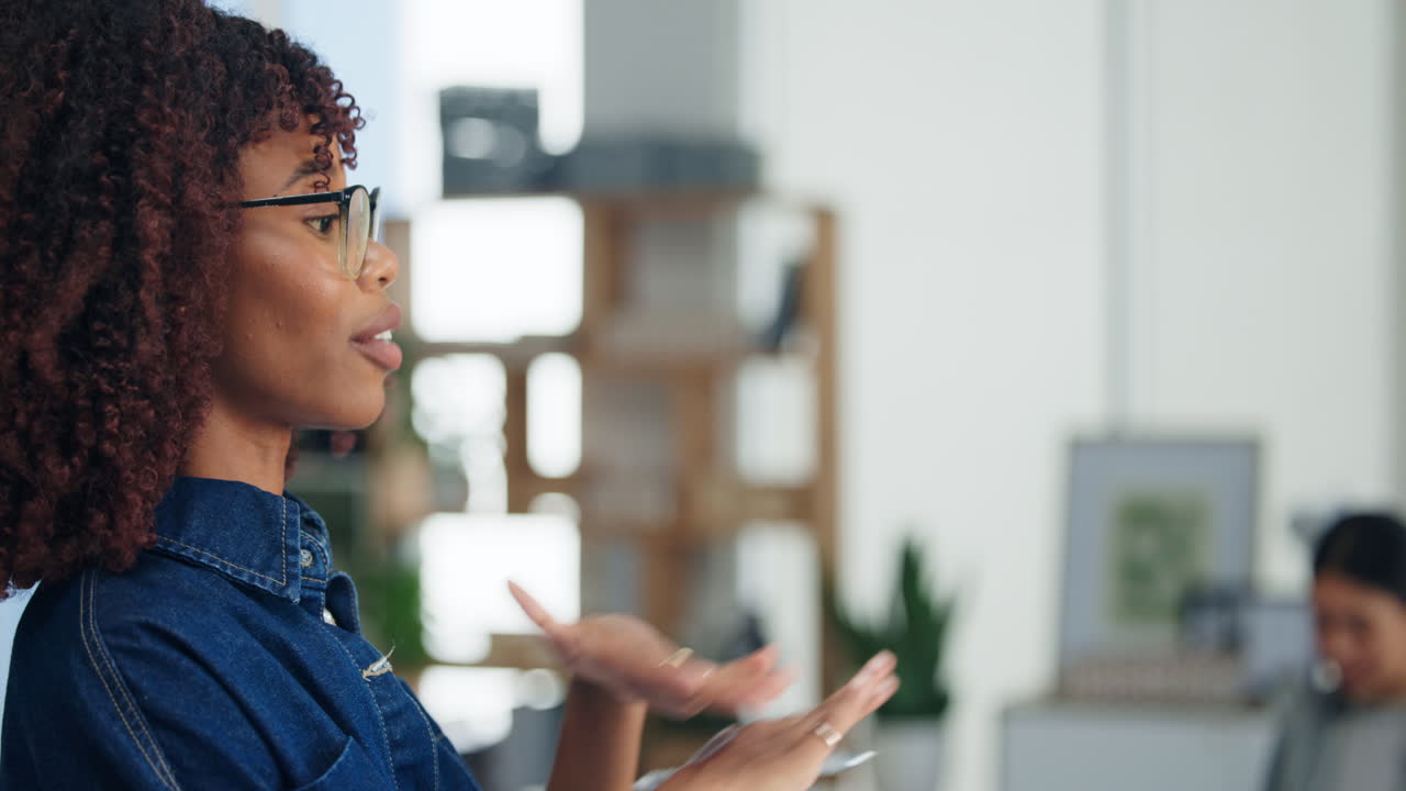 Young African American Woman Talking and Gesturing in Office