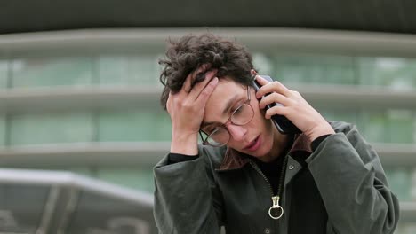 upset woman talking by smartphone on street