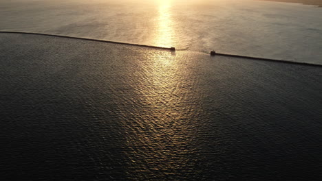 sunset over a breakwater