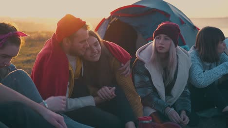 positive hikers spend time at camping with tent and bonfire