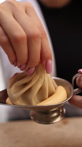 woman eating khinkali