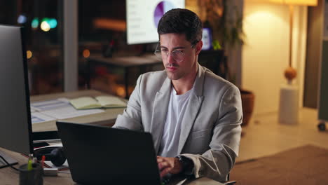 man working late on laptop in office