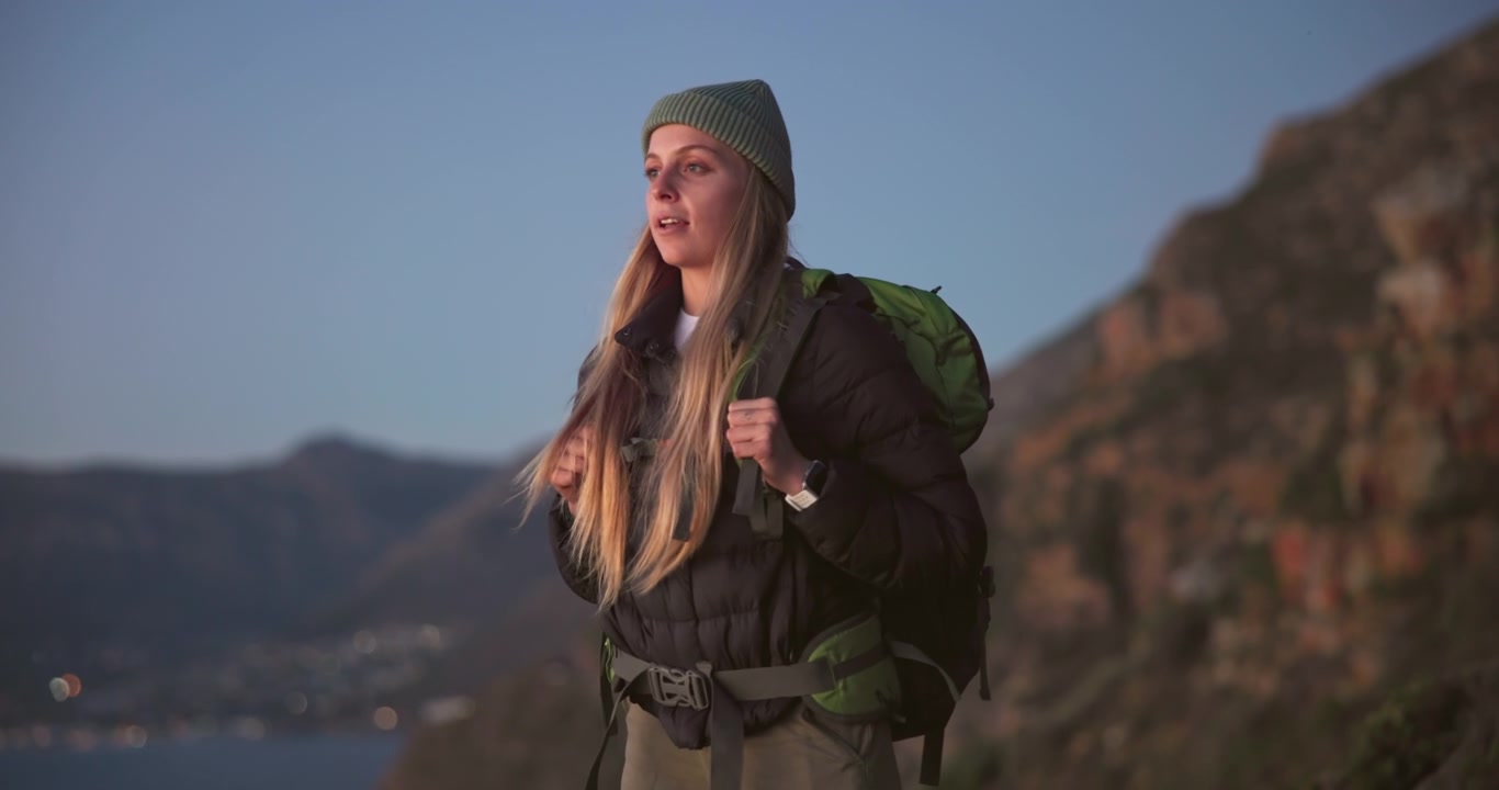 Young Woman Hiker Standing on Mountain Ridge at Sunset