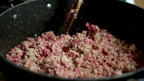chef skillfully mixing minced beef with fresh onions in a sizzling pan, creating a flavorful and mouthwatering meal