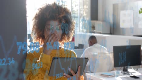 processing data over happy biracial casual businesswoman using tablet in office