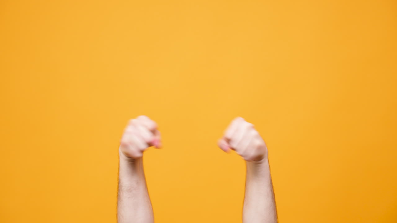 Hands gesturing against an orange background