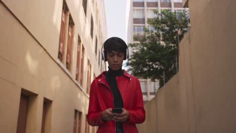 transgender adult listening to music in the street